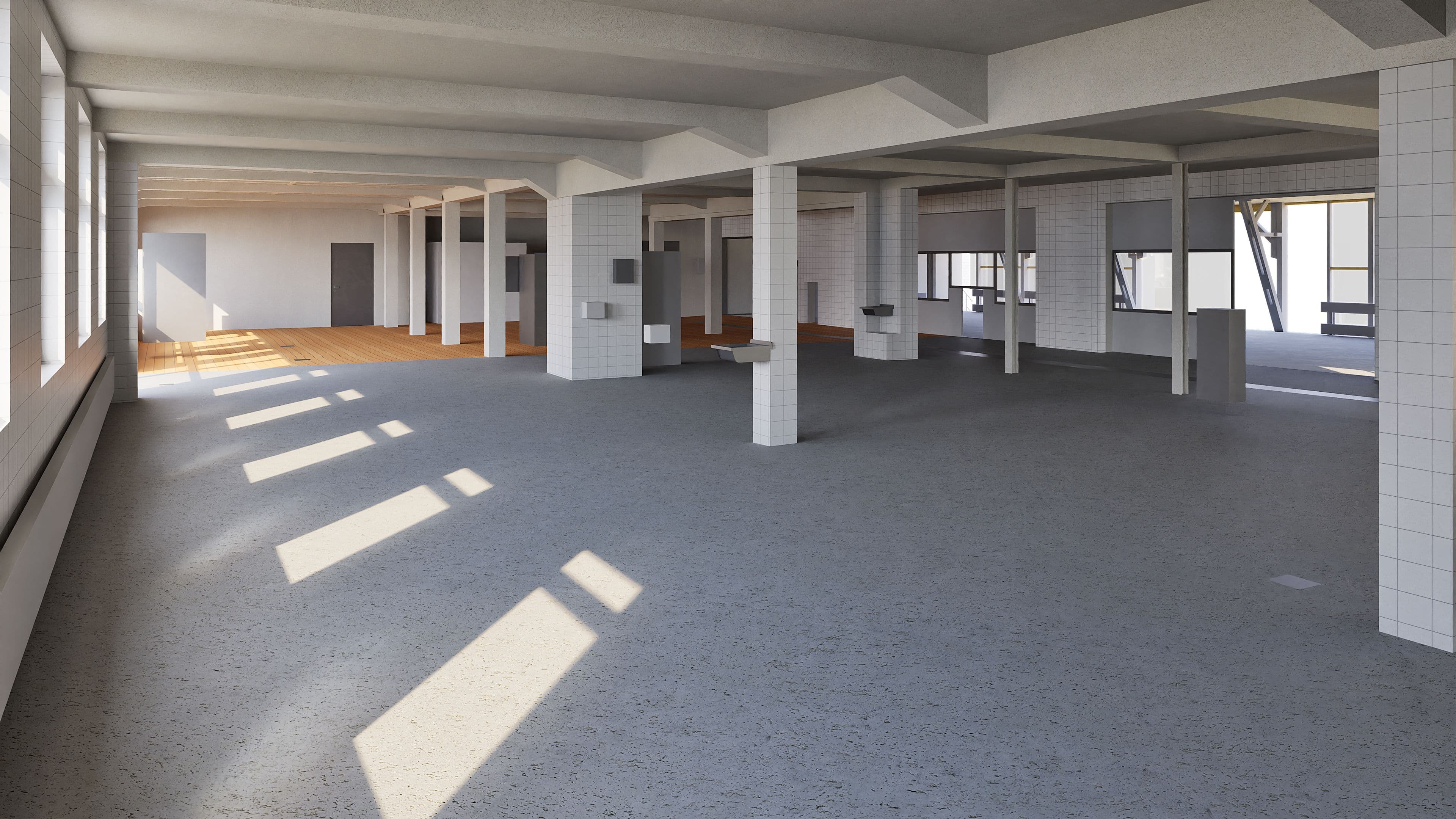 Ein leerer, sonnendurchfluteter Industriebereich mit sichtbaren Betonpfeilern und großen Fenstern.