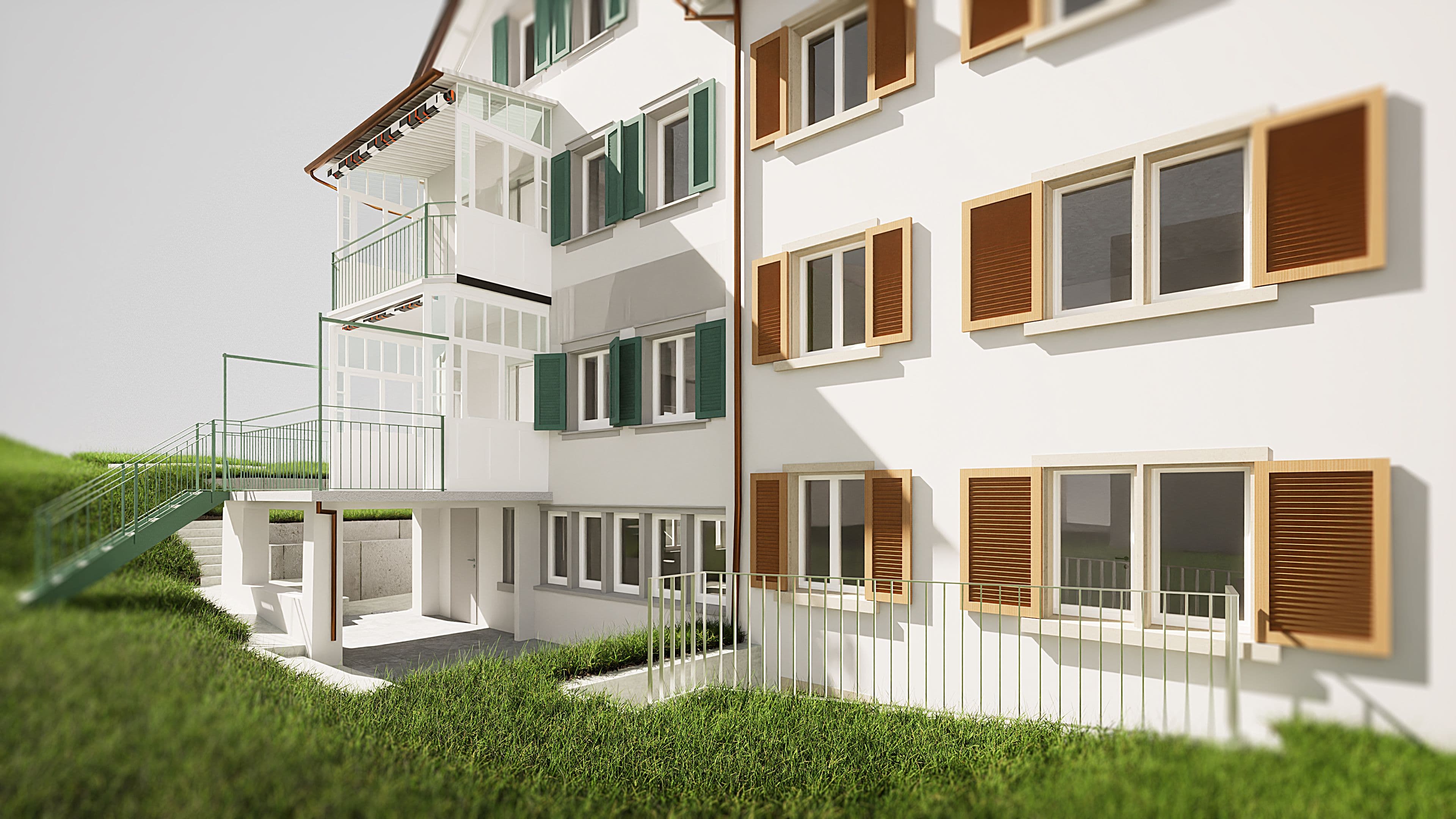 Modernes Mehrfamilienhaus mit Balkonen und grüner Rasenfläche.