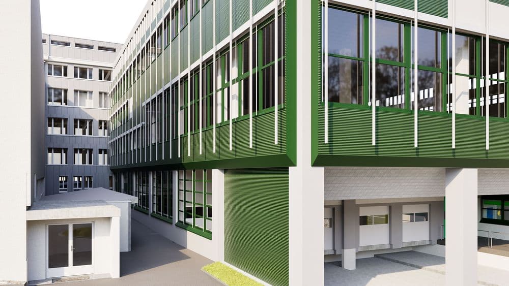 Ein modernes Schulgebäude mit grünen Fassaden und zahlreichen Fenstern in einem urbanen Umfeld.