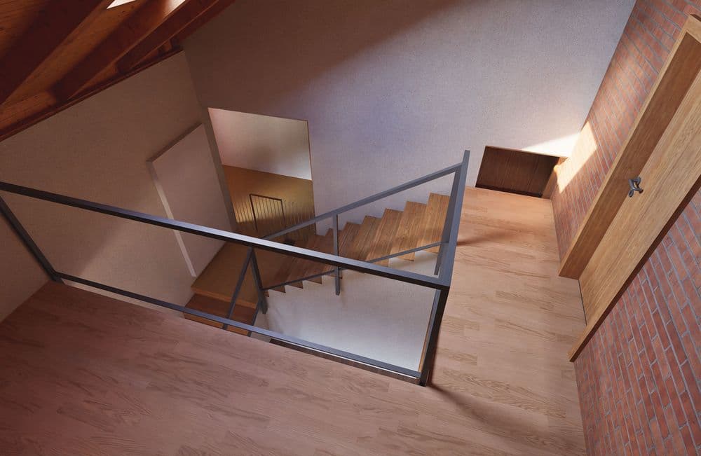 Eine moderne Innentreppe mit Holzgeländer und seitlicher Ziegelwand in einem Haus.