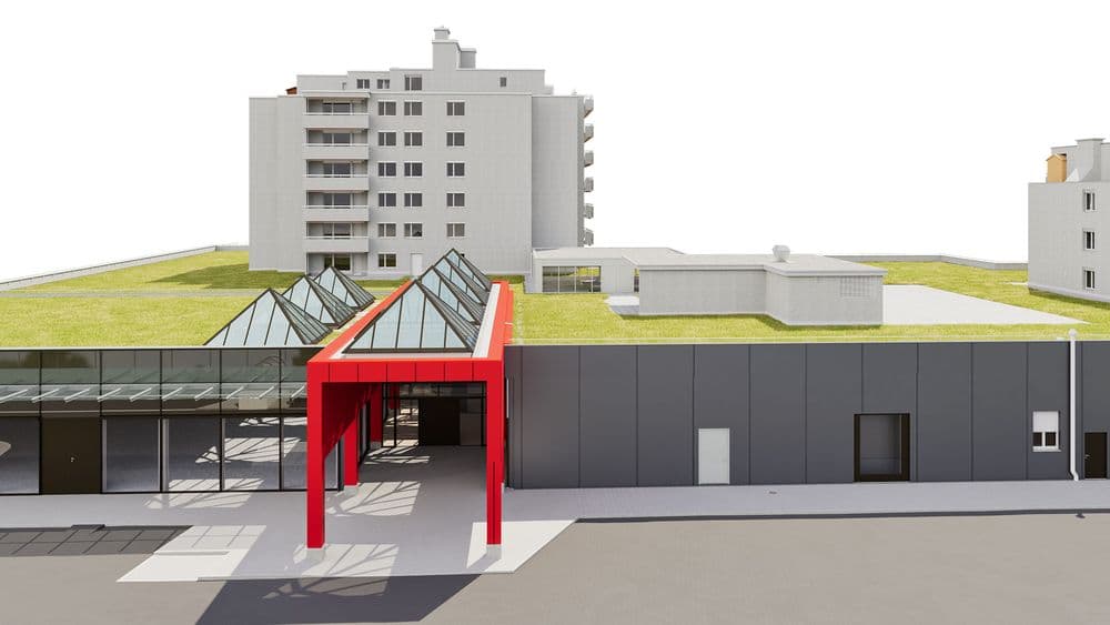 Modernes Gebäude mit begrüntem Dach und auffälligen roten Akzenten vor einem mehrstöckigen Wohnhaus.