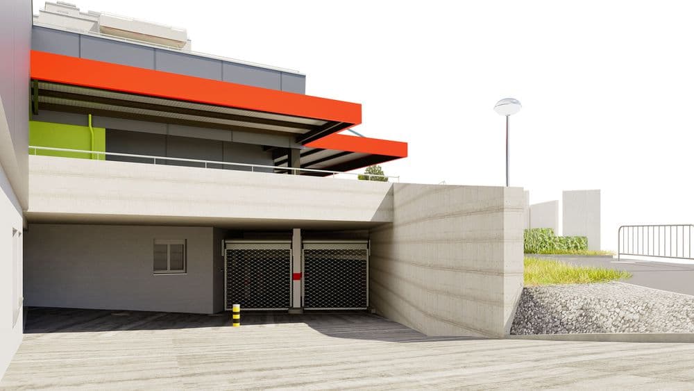 Moderne Architektur mit Beton- und Glasfassade, akzentuiert durch rote und grüne Elemente.