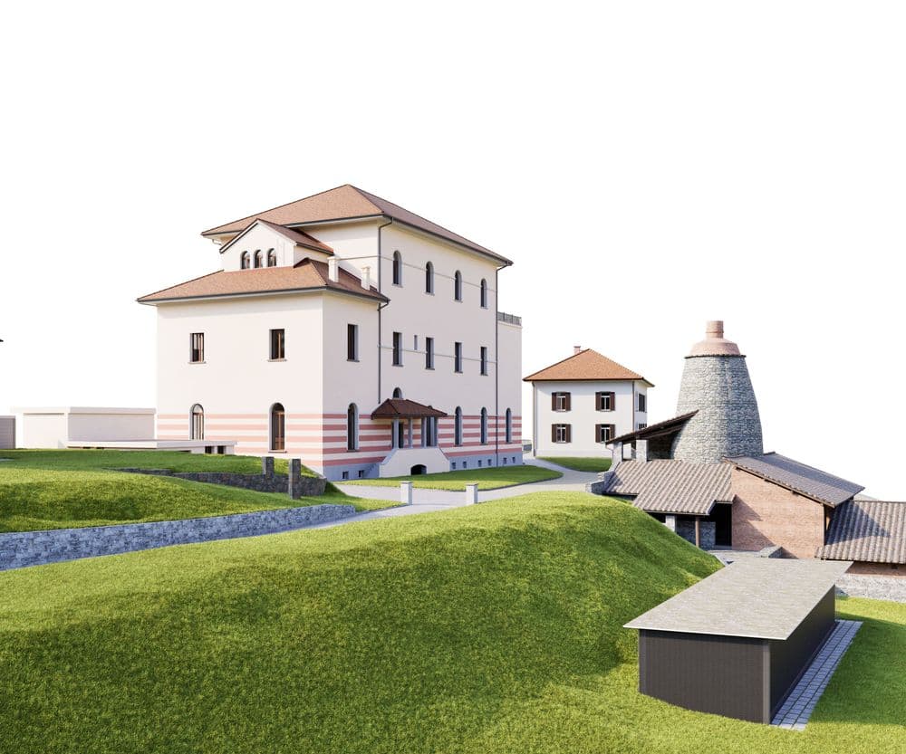 Historischer Gebäudekomplex auf einem grünen Hügel, bestehend aus einer großen Villa und mehreren Nebengebäuden, mit einem traditionellen Kalkofen im Vordergrund.