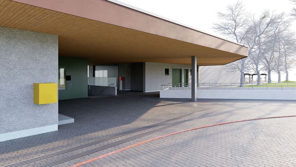 Ein moderner Eingangsbereich mit flachem Dach, umgeben von Bäumen und gepflastertem Boden.