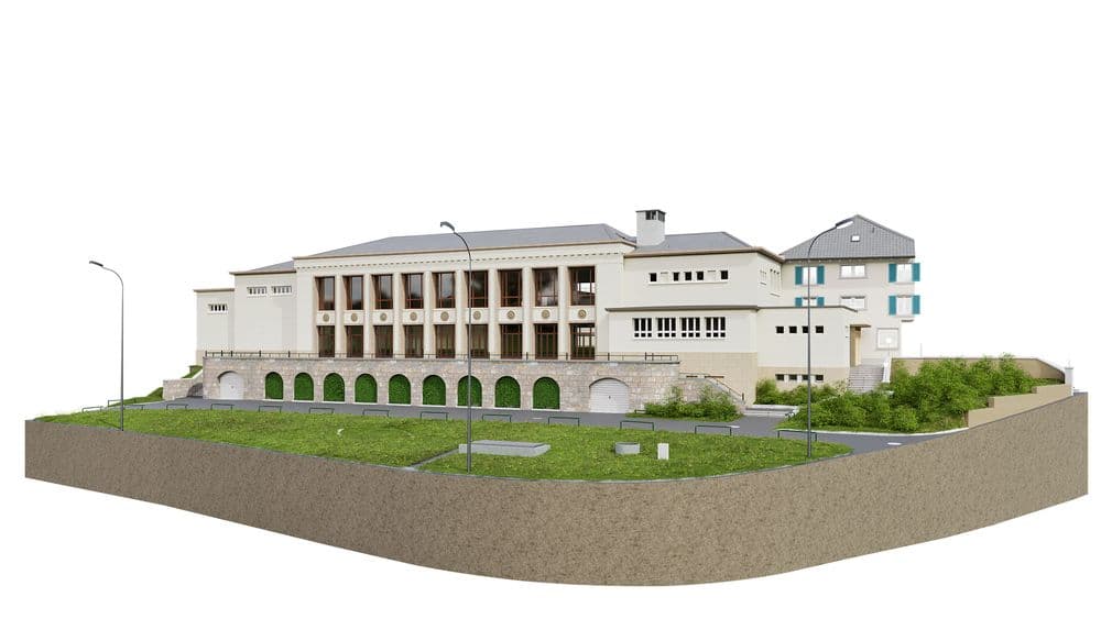 Das Bild zeigt ein historisches Gebäude mit klassischer Architektur, umgeben von Grünflächen und Straßenlaternen.