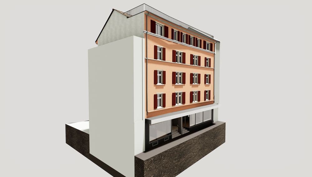 Mehrstöckiges rotes Gebäude mit weißen Fensterrahmen, modernem Erdgeschoss und schrägem Dach.