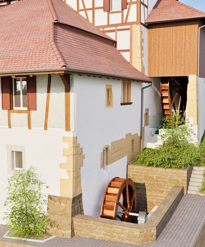 Fachwerkhaus mit Wasserader und Holzrad, umgeben von Pflanzen.