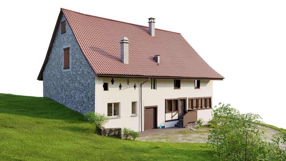 Einfamilienhaus mit rotem Dach auf grüner Wiese, weiße und graue Außenfassade.