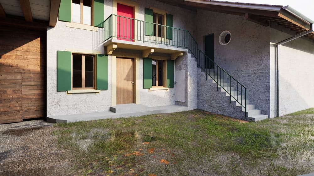 Zweistöckiges Gebäude mit weißen Wänden, grünen Fensterläden und Außentreppe.