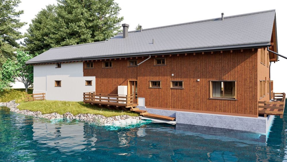3D-Visualisierung eines modernen Holzhauses am Seeufer mit Terrasse, Fenstern und grauem Satteldach, umgeben von Bäumen und Felsen, spiegelndes Wasser im Vordergrund.