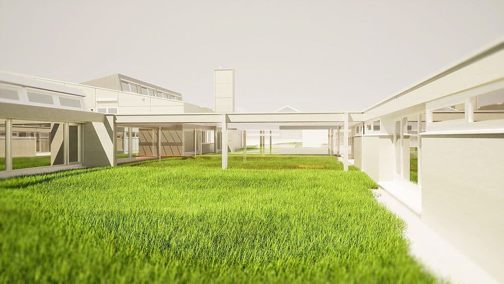 Moderne Architektur eines eingeschossigen Gebäudekomplexes mit grünem Innenhof.