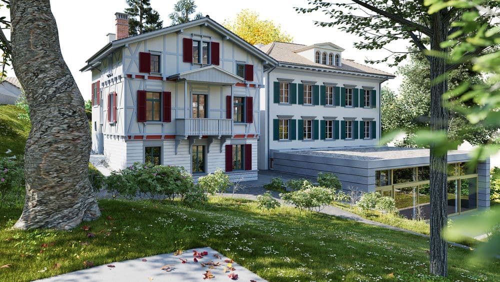 Historische Villa mit roten Fensterläden und modernem Anbau mit Glasfront, umgeben von Garten und Bäumen an einem sonnigen Tag.